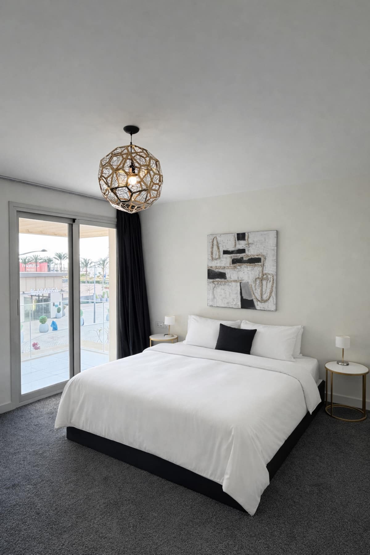 Bright Marassi bedroom with a neatly prepared bed